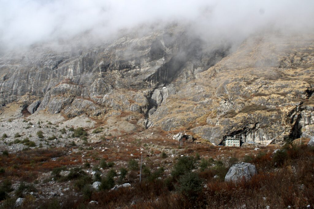 The remains of Langtang Village buried under the rubble of the landslide following the 2015 earthquake. Only one house, on the right, was left standing.
