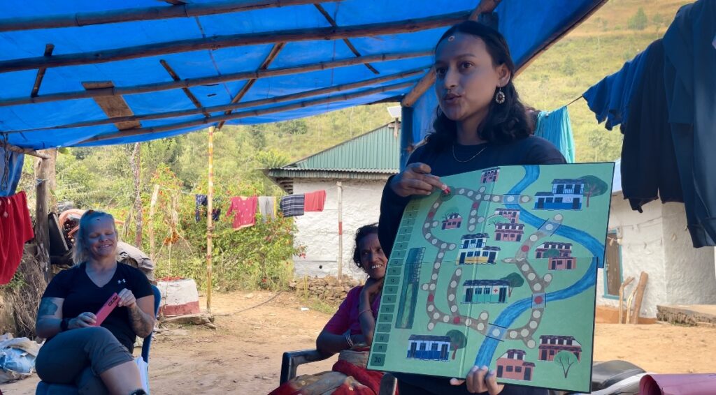 Nirmala explaining the rules of the game in Nepali.
